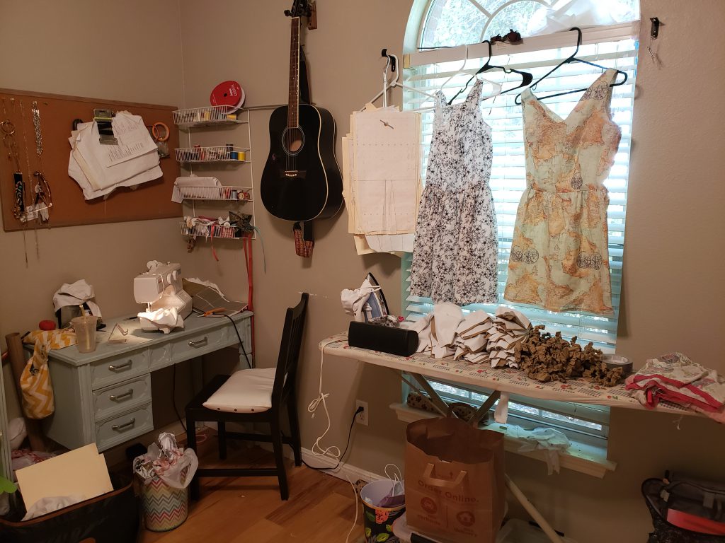 Collins’ workspace before she transitioned on site. The dresses hanging on the window are her original designs. 