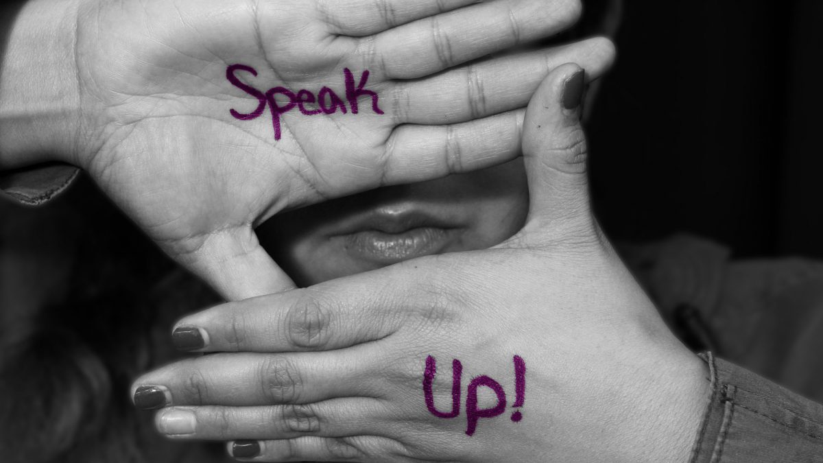 Speak Up written on hands