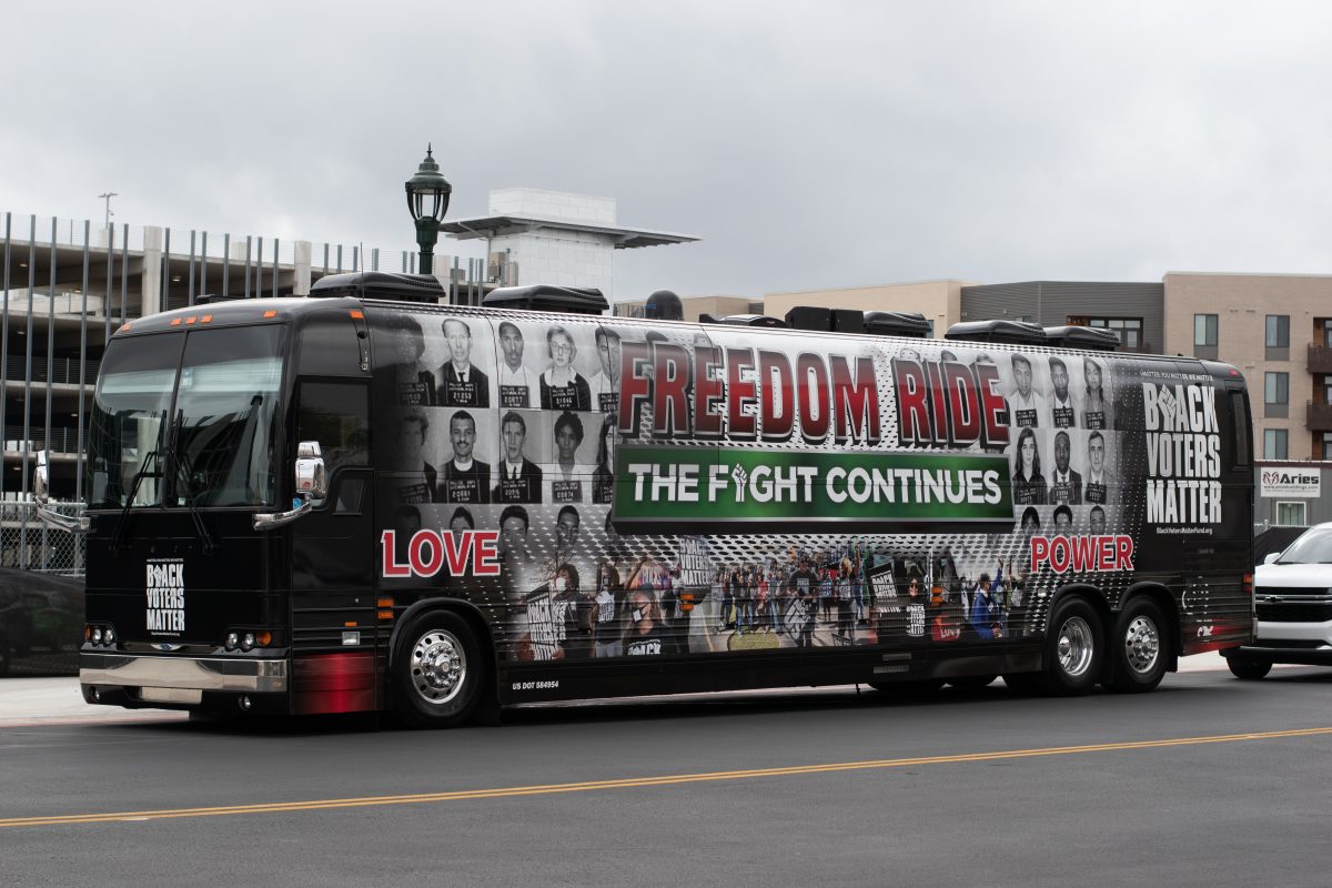 A bus belonging to Black Voters Matter is parked on the street in front of ACC's Highland campus. The words "Freedom Ride the ride continues" is printed in large letters on the side of the bus. The bus also has mugshots of the Freedom Riders of 1961 on it as well.
