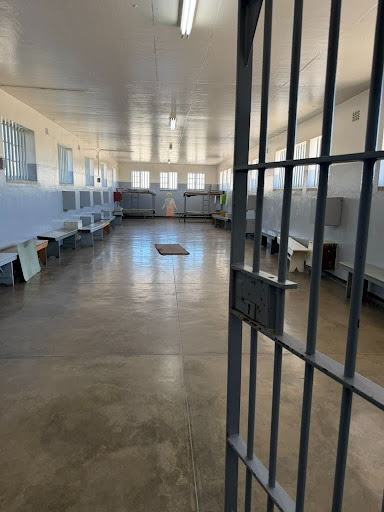 Interior view of a mass group cell at Robben Island maximum security prison, illustrating the crowded and austere living conditions for political prisoners during the apartheid era.