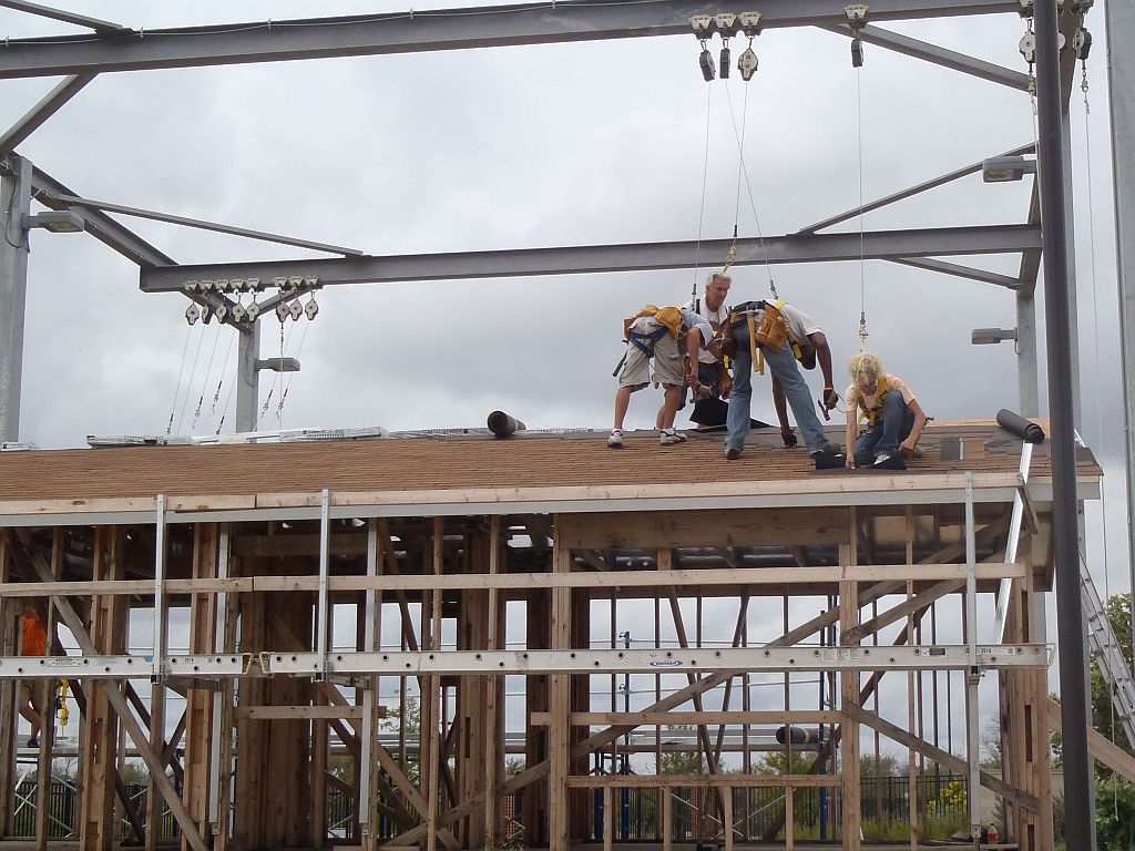 students installing shingled roof