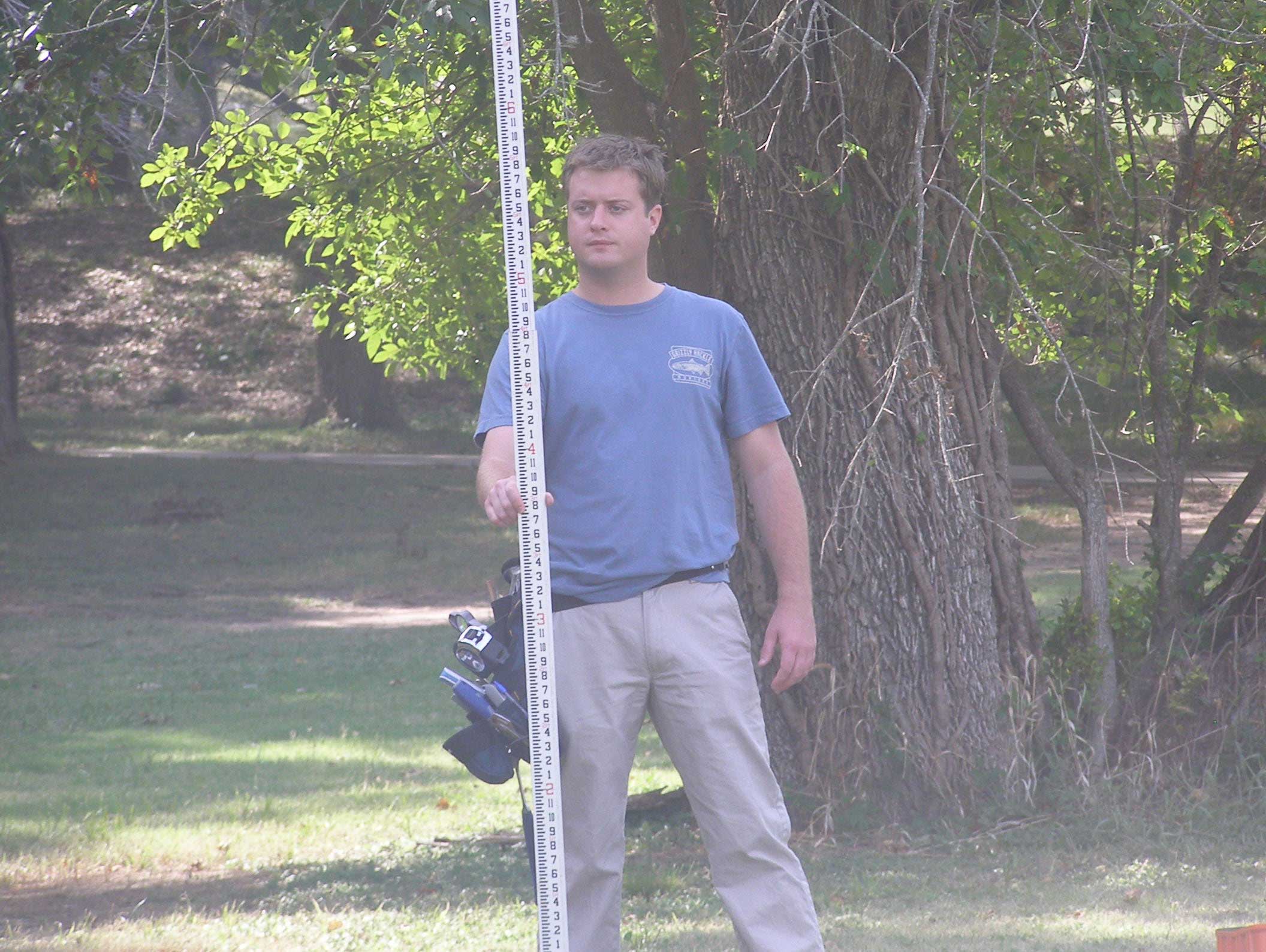 student holding story pole