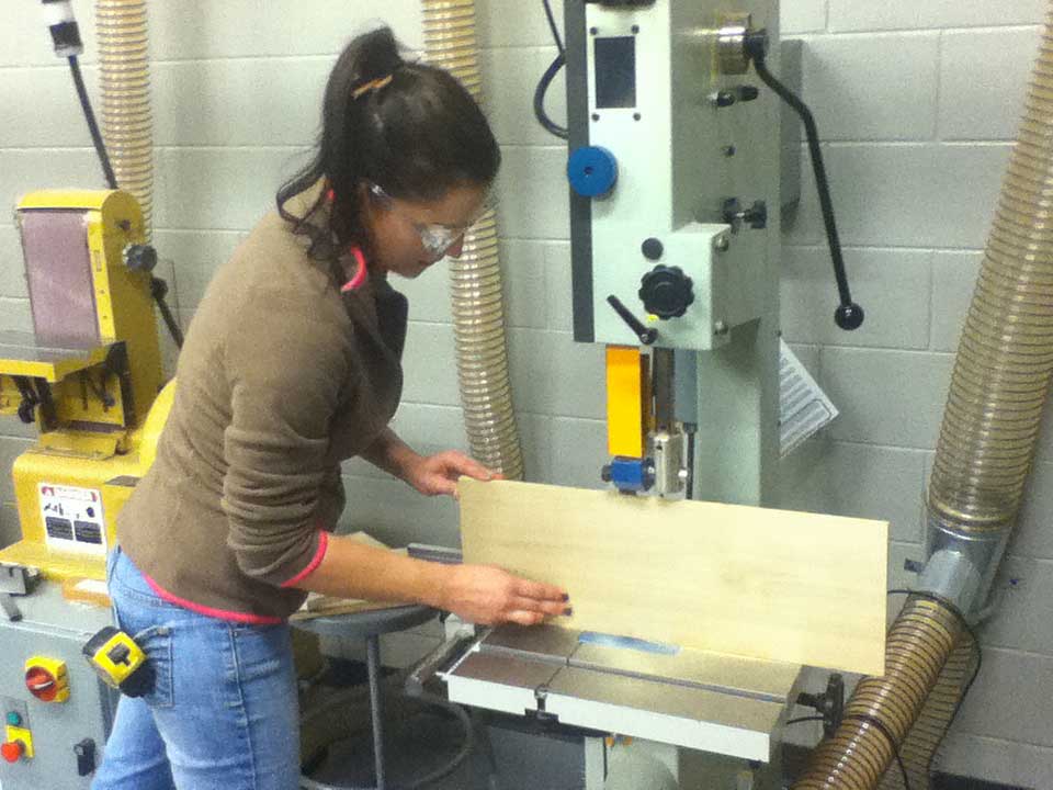student using band saw
