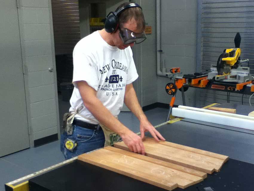 student arranging cut wood pieces
