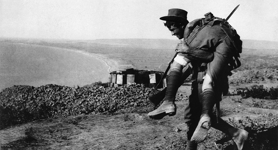  ca. 1915, Turkey --- The irrepressible Australians at Anzac. An Australian bringing in a wounded comrade to hospital. Dardanelles Campaign, ca. 1915. | Location: Gallipoli Penninsula, Turkey. --- Image by © CORBIS