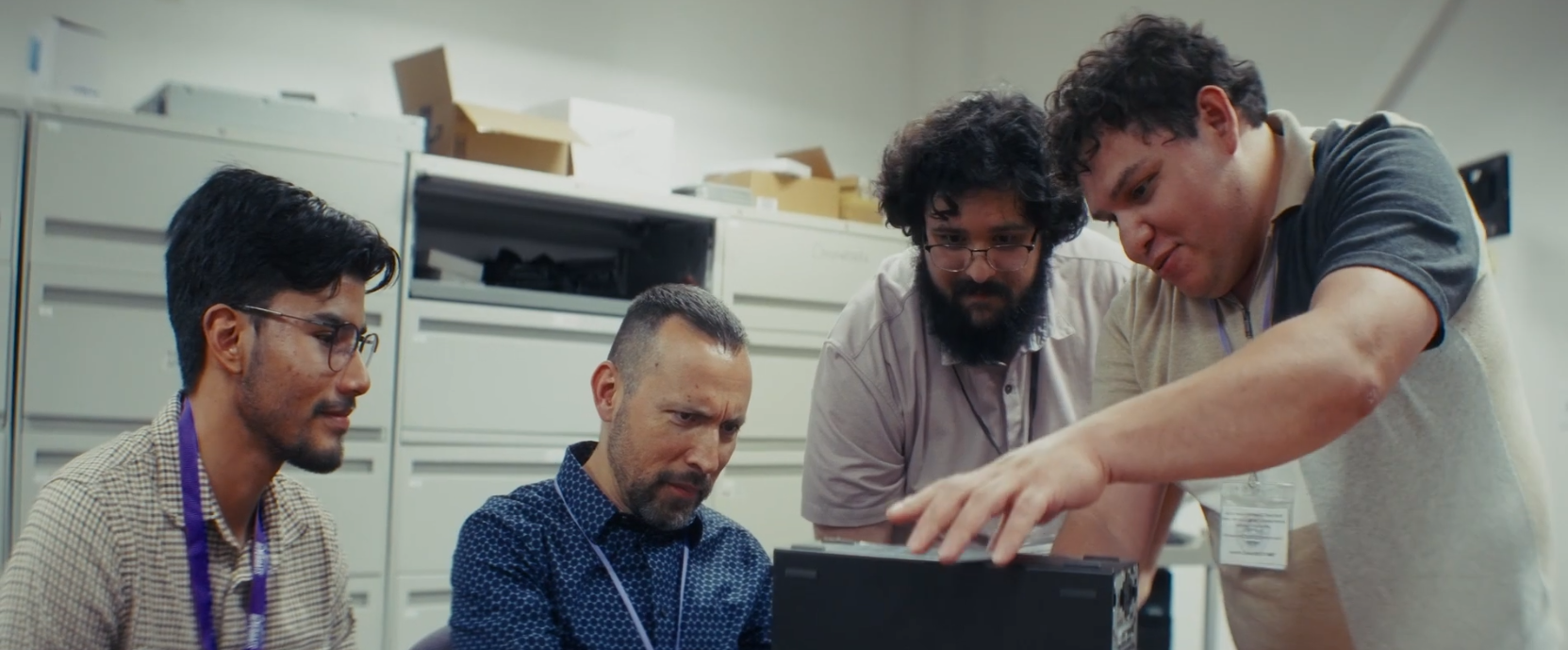 ACC Digital Inclusion Internship students collaborate with an instructor while troubleshooting a desktop computer during a hands-on IT training session.