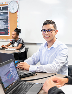 Latino student working on a laptop computer