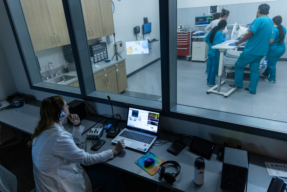 Control room watches students perform interdepartmental healthcare scenario training