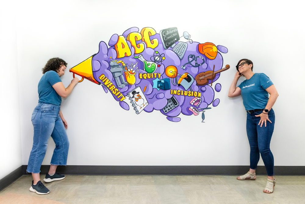 ACC student Danielle Moak and her supervisor Samantha Thomson pose with the new mural created by Moak at the ACC Northridge Campus Welcome Center on Monday, June 12, 2023.