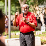 Professor Roland Hayes speaking outside during an event