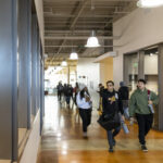 ACC students walk down hallway at ACC Highland Campus