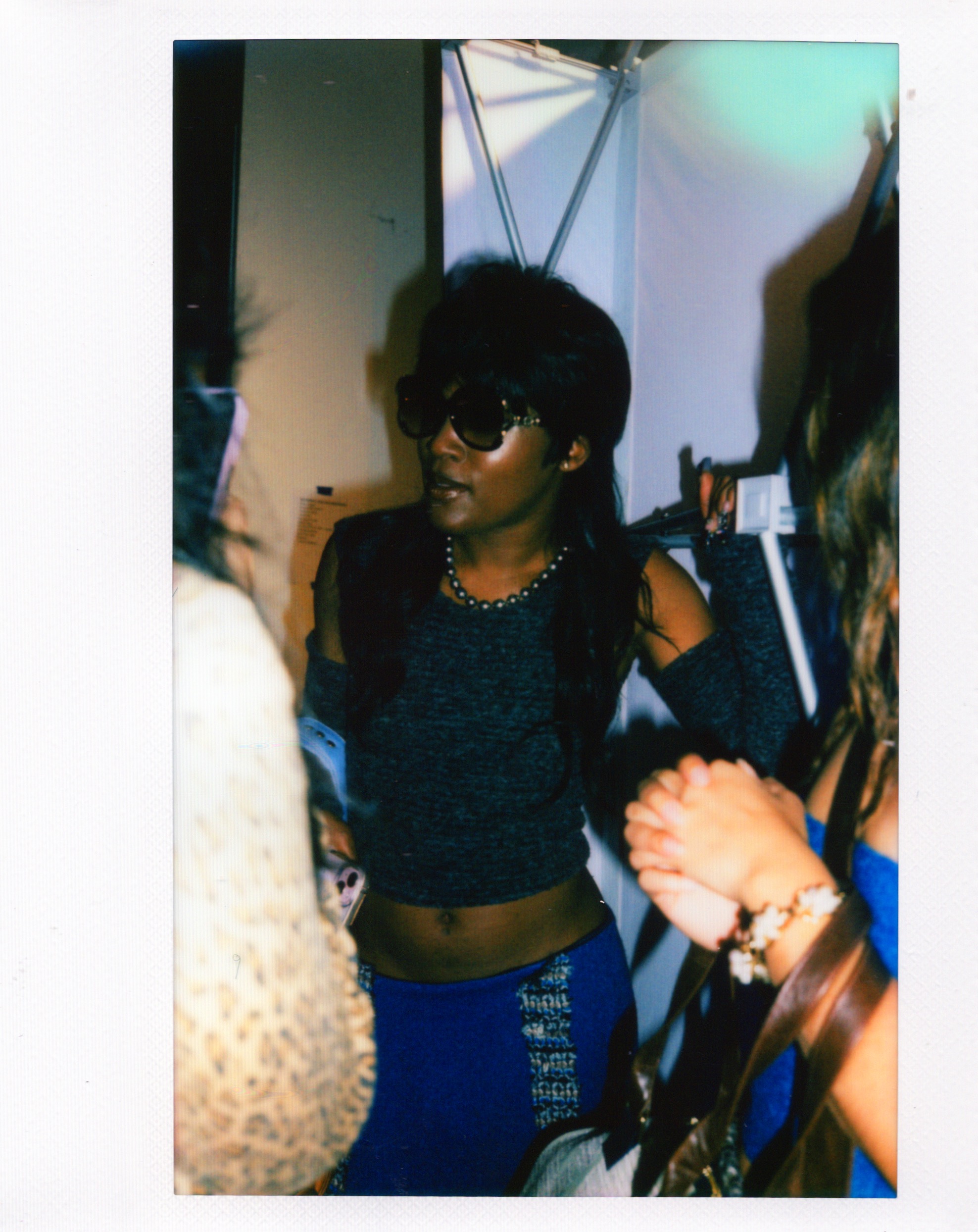 Woman poses in front other students before Fashion Show