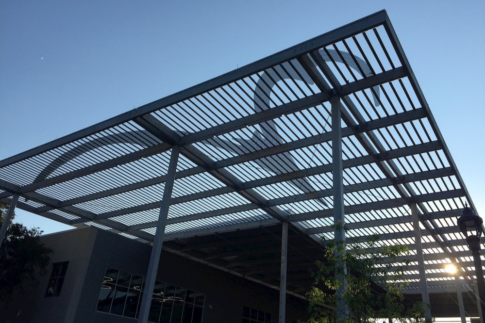 Upward facing photo of Riverbat canopy with sun light streaming through at Highland Campus paseo