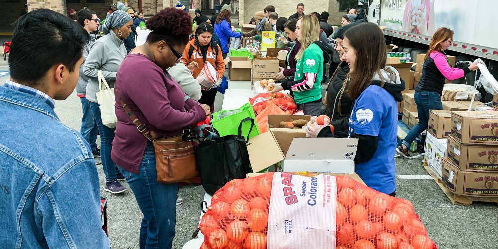 Volunteers distributing food at distribution event