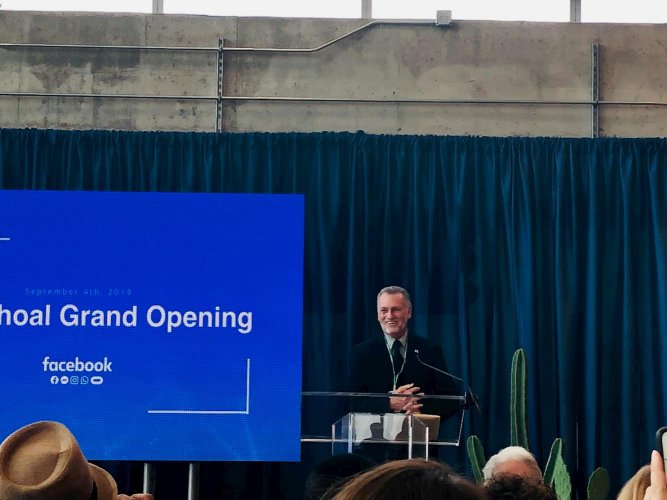 Dr. Richard Rhodes behind podium at ceremonial grand opening