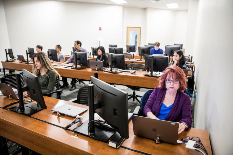 Male and female students working on computers in computer lab