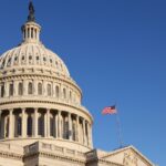US Capitol dome image with american flag and blue sky