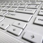 Close-up view of a computer keyboard, showcasing keys and layout in detail.