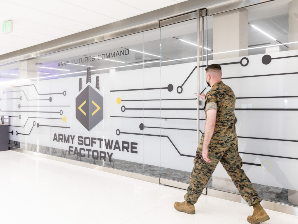 Soldier walking by Army Software Factory
